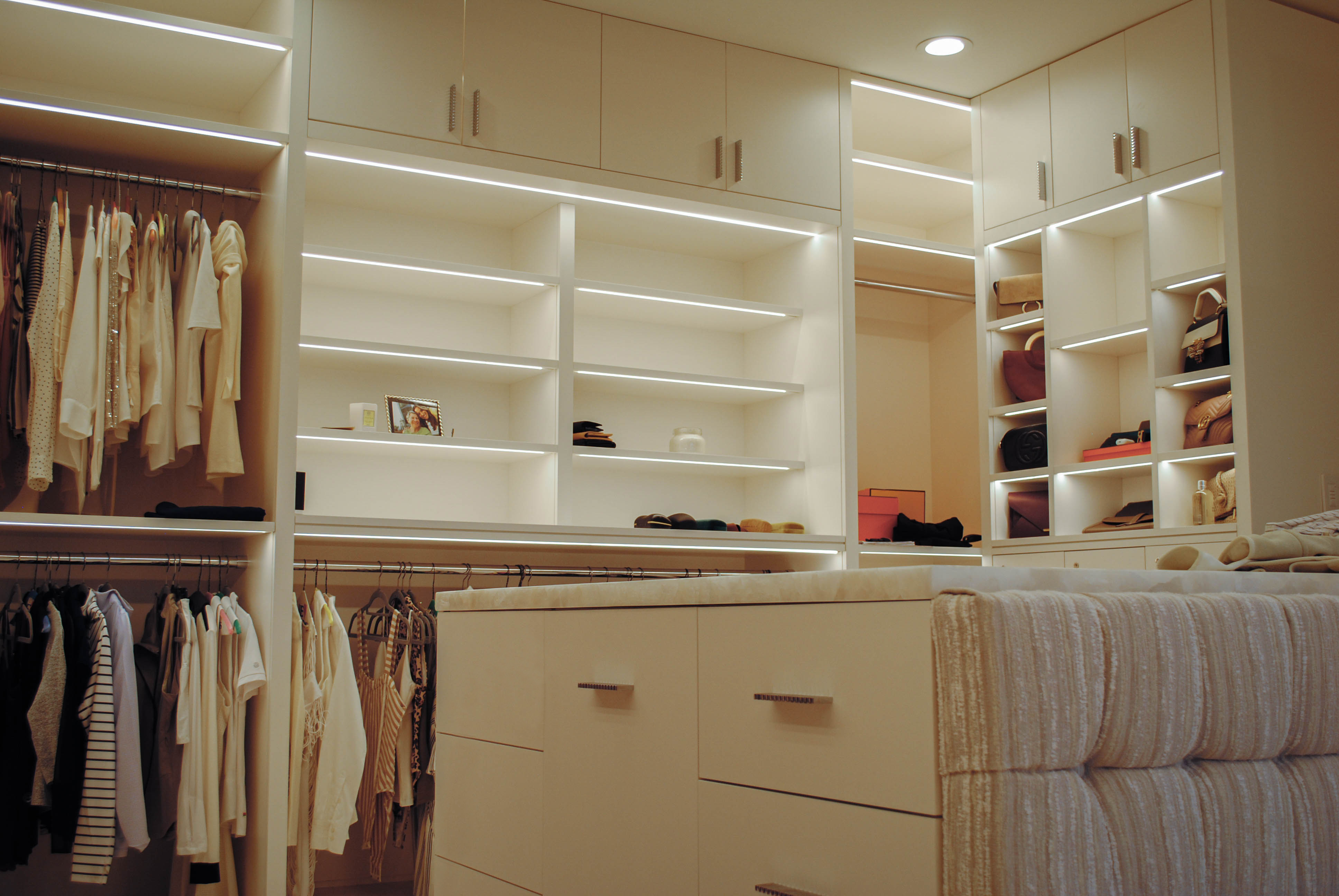 Walk In Closet featuring custom millwork